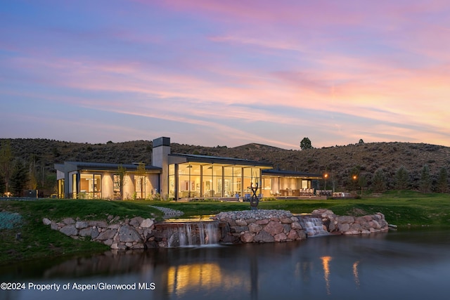 6890 E Sopris Creek Rd, Snowmass, CO 81654 - rear view of property with a lawn, a water and mountain view, and a chimney
