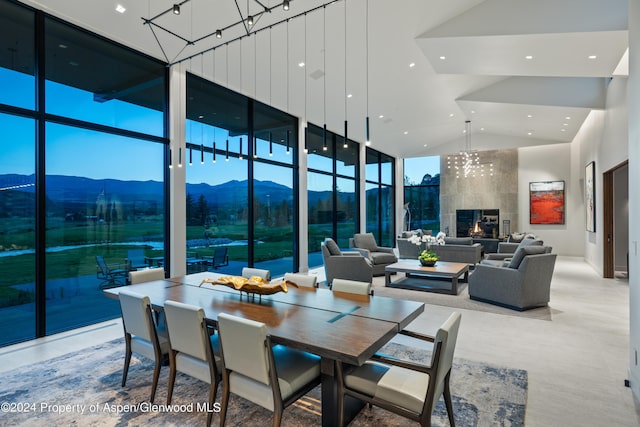 6890 E Sopris Creek Rd, Snowmass, CO 81654 - dining area featuring a high ceiling, a mountain view, recessed lighting, a wall of windows, and a chandelier