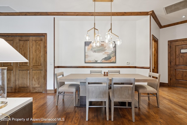 dining room featuring dark hardwood / wood-style flooring and crown molding