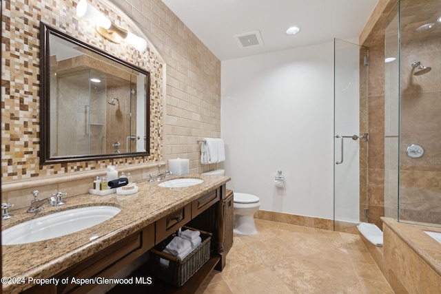 bathroom featuring backsplash, vanity, toilet, and walk in shower