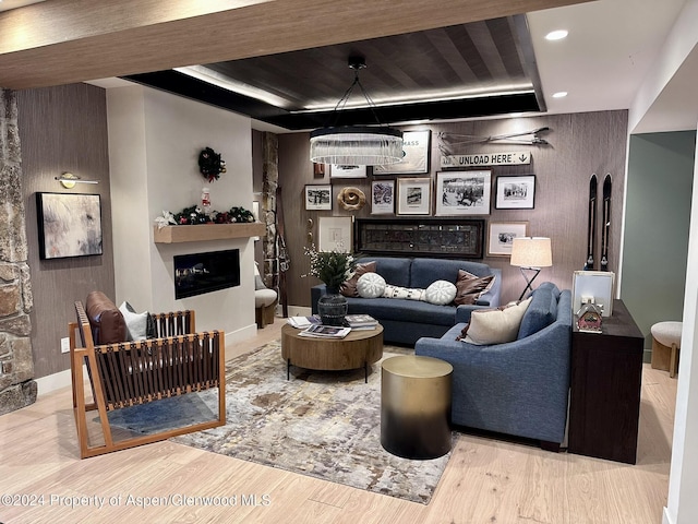 living room featuring light hardwood / wood-style flooring and a notable chandelier