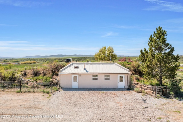 40889 County Road 76a, Hayden, CO 81639 - view of front facade with a mountain view, stucco siding, and a view of countryside