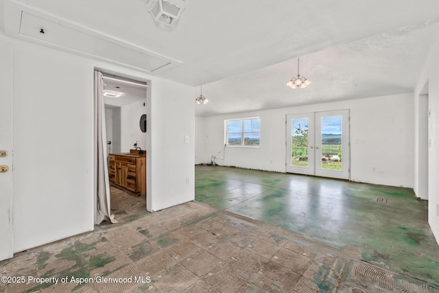 40889 County Road 76a, Hayden, CO 81639 - unfurnished living room with attic access, french doors, and concrete flooring