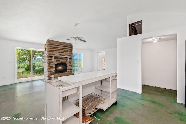 40889 County Road 76a, Hayden, CO 81639 - kitchen featuring ceiling fan, plenty of natural light, a fireplace, vaulted ceiling, and concrete floors