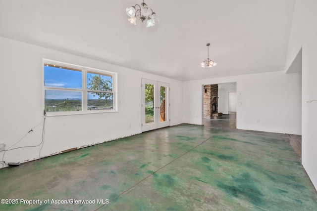 40889 County Road 76a, Hayden, CO 81639 - unfurnished living room featuring a chandelier, finished concrete floors, and vaulted ceiling
