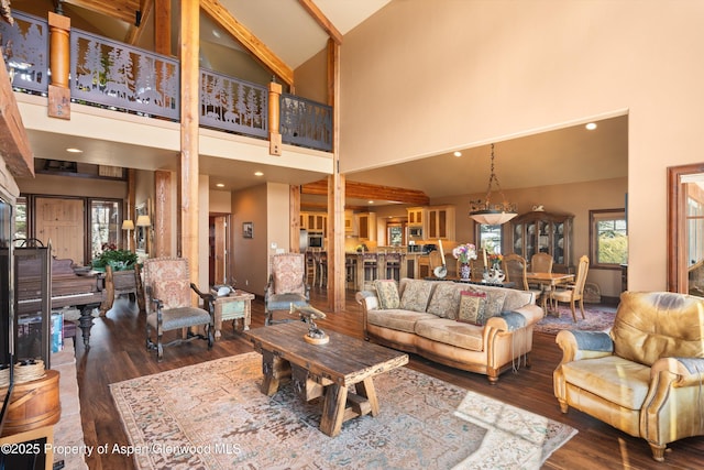 living area featuring high vaulted ceiling, wood finished floors, and recessed lighting