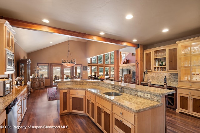 kitchen with lofted ceiling with beams, dark wood-style flooring, a sink, appliances with stainless steel finishes, and glass insert cabinets