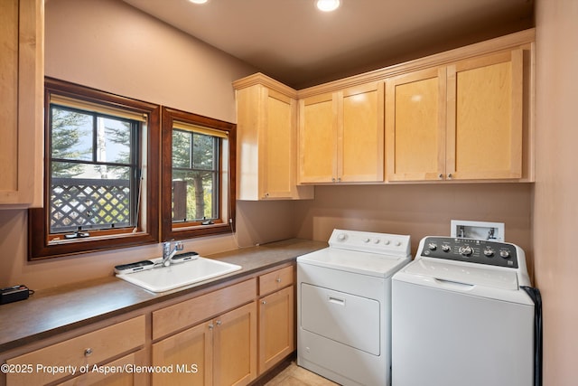 clothes washing area with washing machine and dryer, cabinet space, a sink, and recessed lighting