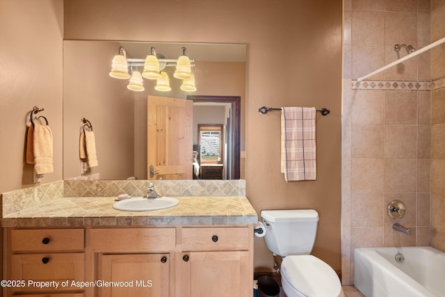 bathroom featuring tub / shower combination, vanity, and toilet