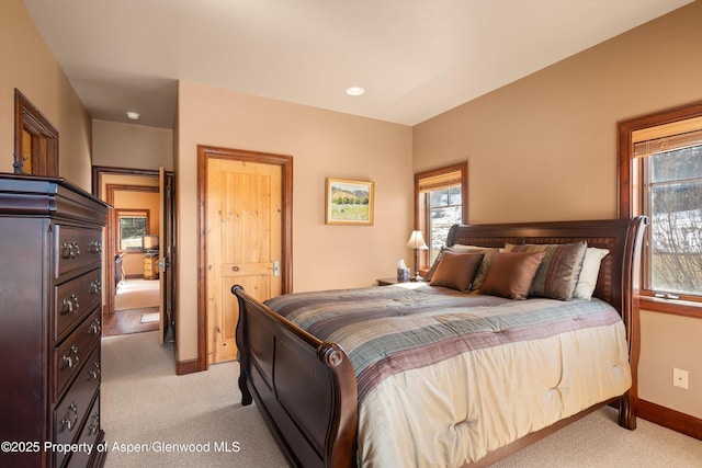 bedroom featuring light carpet and baseboards