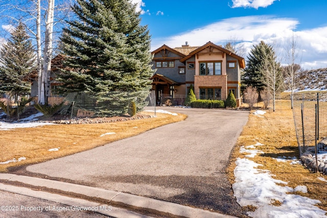 view of front of house featuring driveway and a chimney