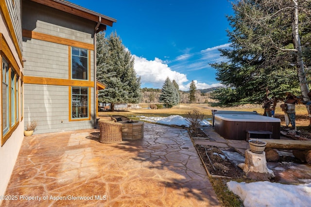 view of patio / terrace with a hot tub