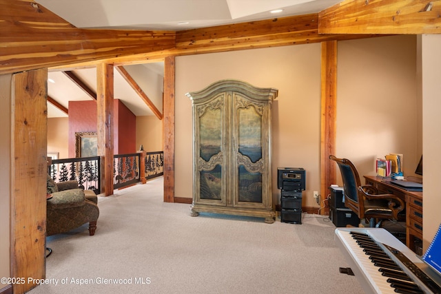 carpeted home office featuring vaulted ceiling with beams