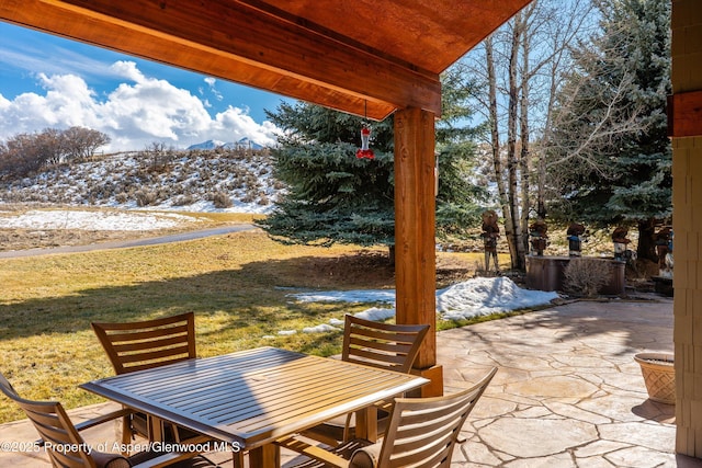 view of patio / terrace with a mountain view and outdoor dining space