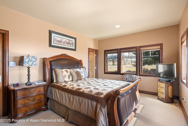 bedroom featuring light colored carpet and baseboards