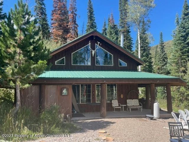 back of property with a porch