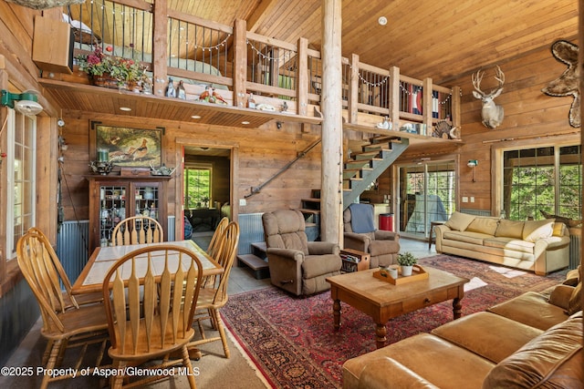 0 E Divide Creek Rd, Silt, CO 81652 - living area featuring high vaulted ceiling, wood walls, wooden ceiling, and stairs