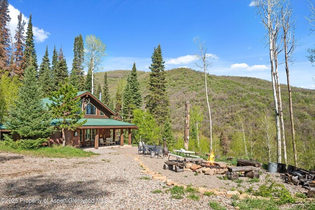 0 E Divide Creek Rd, Silt, CO 81652 - view of yard with a fire pit, a forest view, and a patio