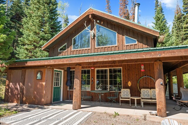 0 E Divide Creek Rd, Silt, CO 81652 - back of property with board and batten siding and a patio area