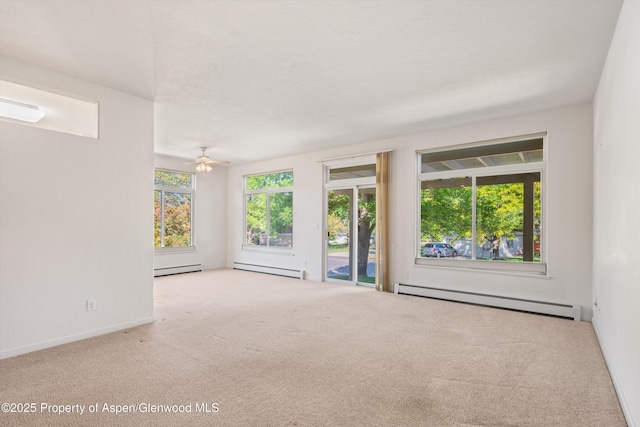55 Limberpine Cir, Battlement Mesa, CO 81635 - carpeted empty room with baseboard heating, ceiling fan, baseboards, and a baseboard radiator