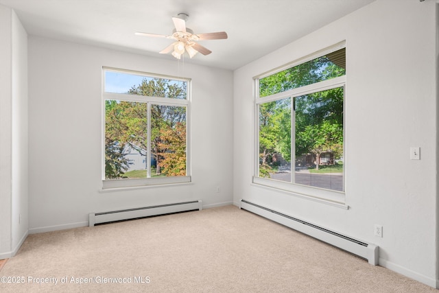 55 Limberpine Cir, Battlement Mesa, CO 81635 - carpeted empty room featuring a baseboard radiator, plenty of natural light, and ceiling fan