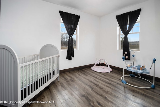 bedroom featuring wood finished floors and baseboards