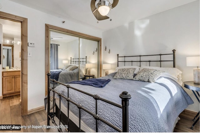 bedroom featuring a sink, a closet, wood finished floors, and a ceiling fan