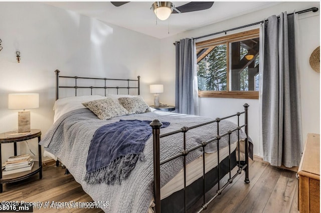 bedroom featuring a ceiling fan and wood finished floors