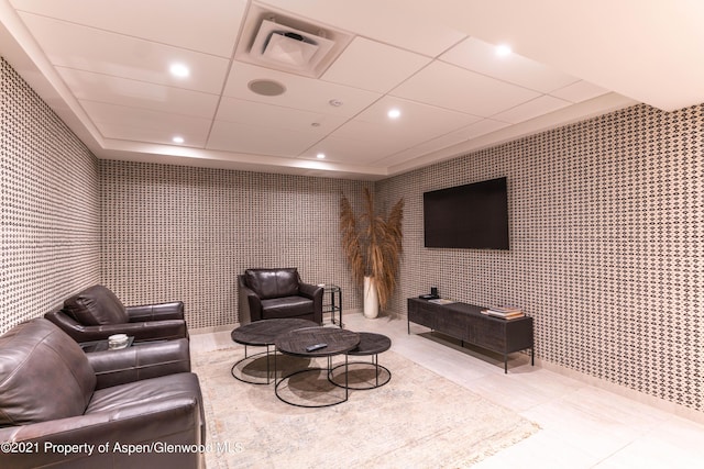 tiled living room with a paneled ceiling