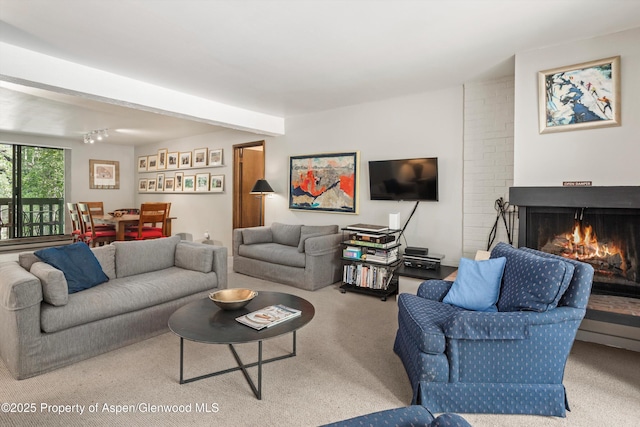 1024 E Hopkins Ave # 16, Aspen, CO 81611 - living area with carpet, a brick fireplace, and beam ceiling