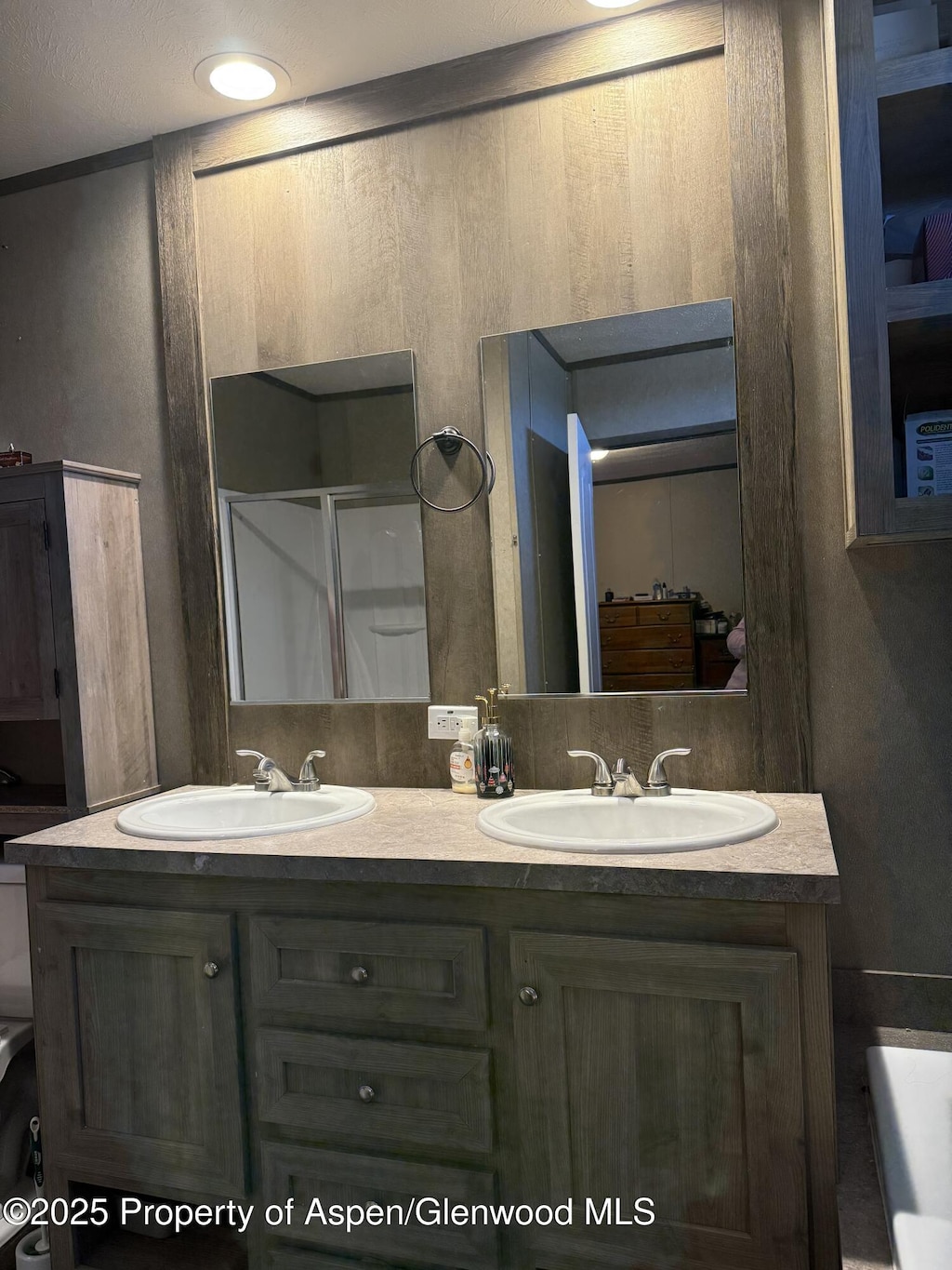 200 W 20th St Unit C2, Rifle, CO 81650 - bathroom featuring double vanity, a sink, and a stall shower