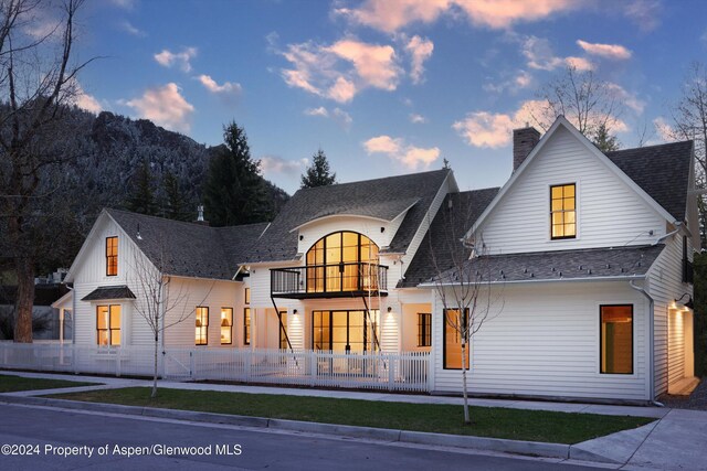 modern inspired farmhouse featuring a balcony