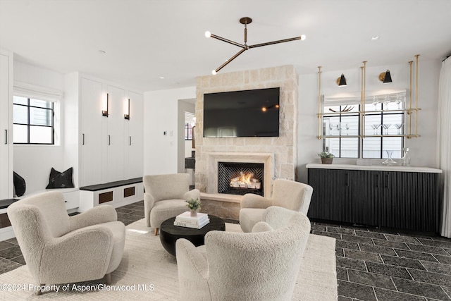 living room with a fireplace and a notable chandelier