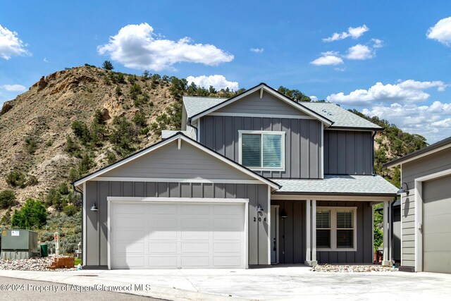 view of front property featuring a porch and a garage