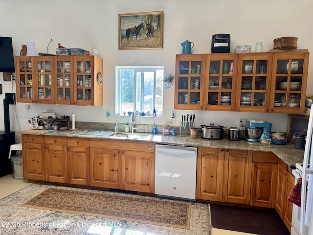 6398 County Road 4, Meeker, CO 81641 - kitchen featuring white dishwasher, brown cabinets, glass insert cabinets, range, and light stone countertops