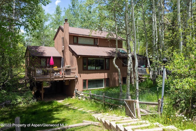 rear view of property with a wooden deck