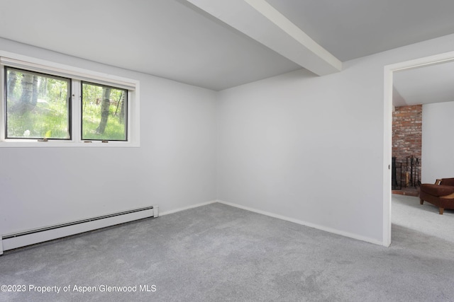 spare room featuring beam ceiling, baseboard heating, and light carpet