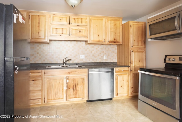 kitchen featuring light brown cabinetry, decorative backsplash, sink, and appliances with stainless steel finishes