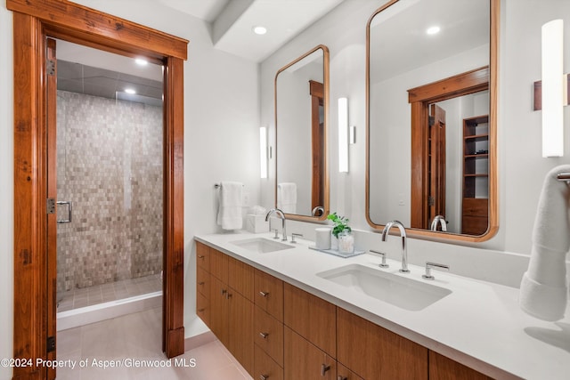 bathroom with vanity, tile patterned flooring, and a shower with door