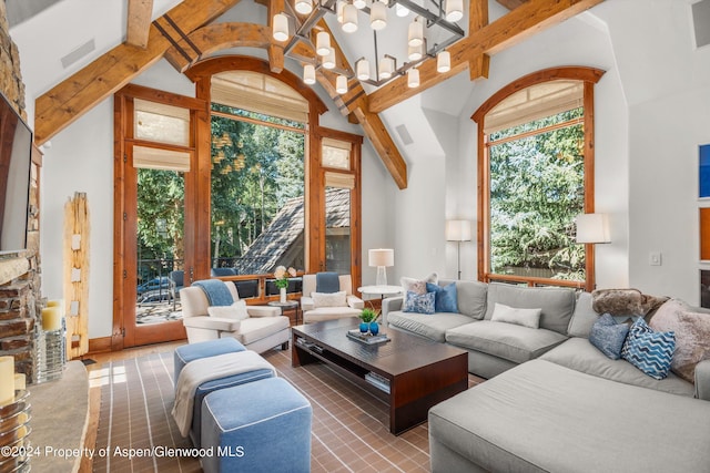 tiled living room featuring high vaulted ceiling, beam ceiling, and a notable chandelier