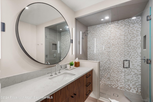 bathroom with vanity, tile patterned flooring, and a shower with door