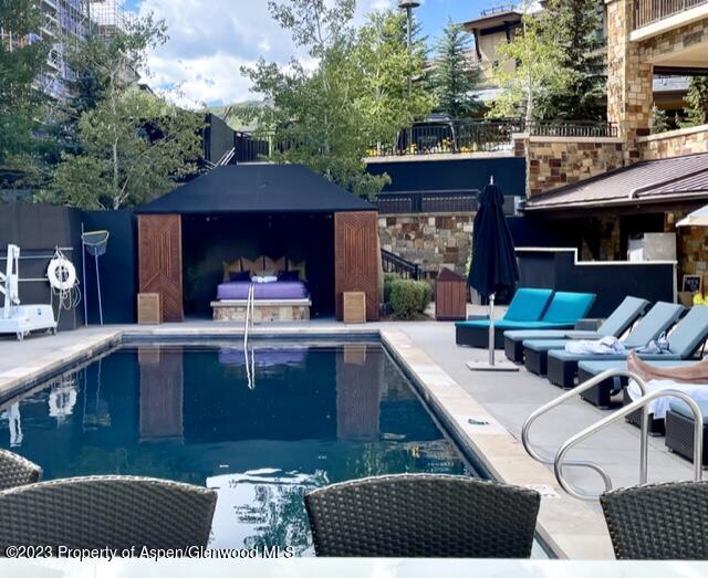 view of swimming pool featuring a patio area and a grill