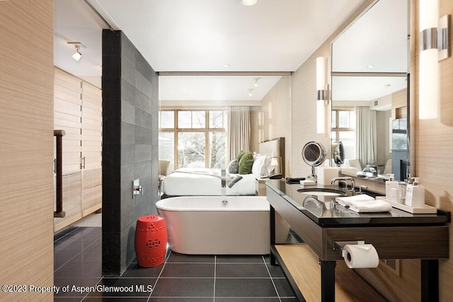 bathroom with tile patterned flooring, vanity, and a bathtub