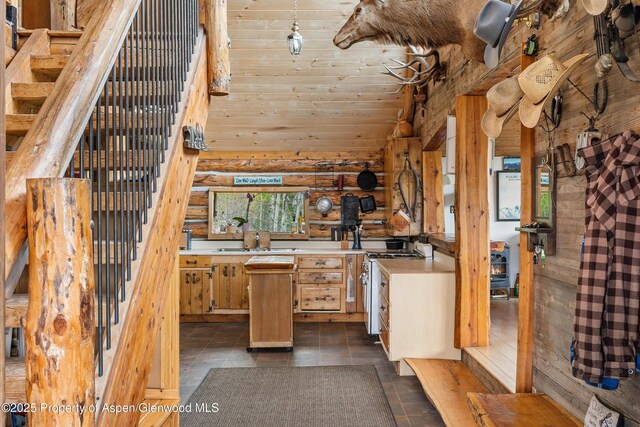 3714 Bear Ridge Rd, Basalt, CO 81621 - kitchen featuring a sink, range with gas stovetop, light countertops, rustic walls, and lofted ceiling
