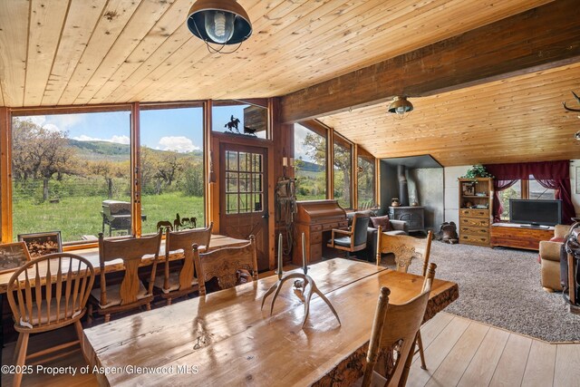3714 Bear Ridge Rd, Basalt, CO 81621 - dining space with a wood stove, wood ceiling, and wood-type flooring
