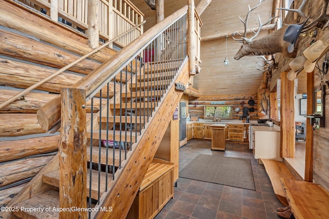 3714 Bear Ridge Rd, Basalt, CO 81621 - stairs featuring a high ceiling, log walls, wooden ceiling, and stone finish floors