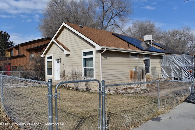 view of side of property with solar panels