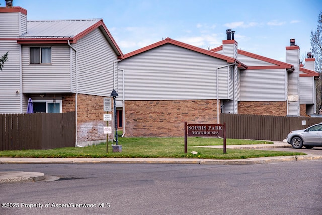 681 S 2nd St Unit A, Carbondale, CO 81623 - view of side of property featuring fence, a chimney, and brick siding