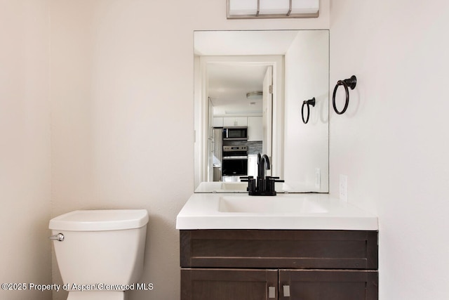 681 S 2nd St Unit A, Carbondale, CO 81623 - half bath featuring toilet, vanity, and backsplash