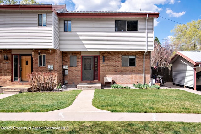 681 S 2nd St Unit A, Carbondale, CO 81623 - view of front facade with fence, a front lawn, and brick siding